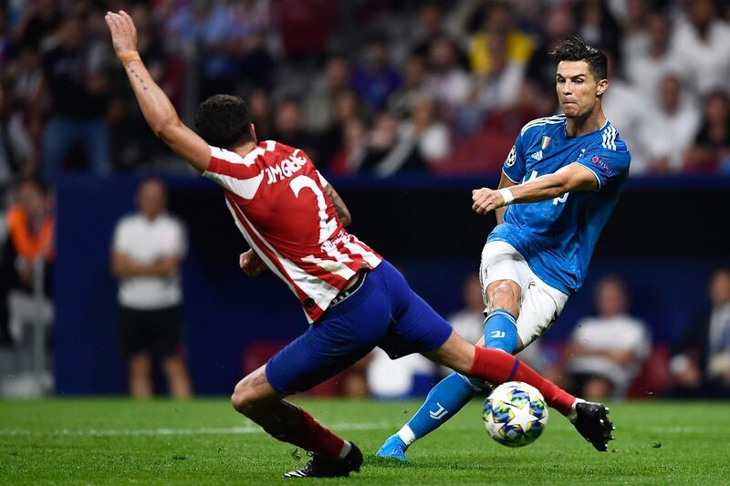 Juventus' Portuguese forward Cristiano Ronaldo vies for the ball with Atletico Madrid's Uruguayan defender Jose Gimenez. AFP