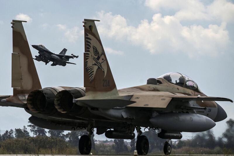 A Hellenic Air Force F-16 jet takes off behind an Israeli F-15 from the military airport of Andravida, southern Greece, on April 19, 2021. - Led by the Hellenic Air Force, "INIOCHOS 2021" multinational aviation exercise is underway over the entirety of Greece's FIR. (Photo by ARIS MESSINIS / AFP)