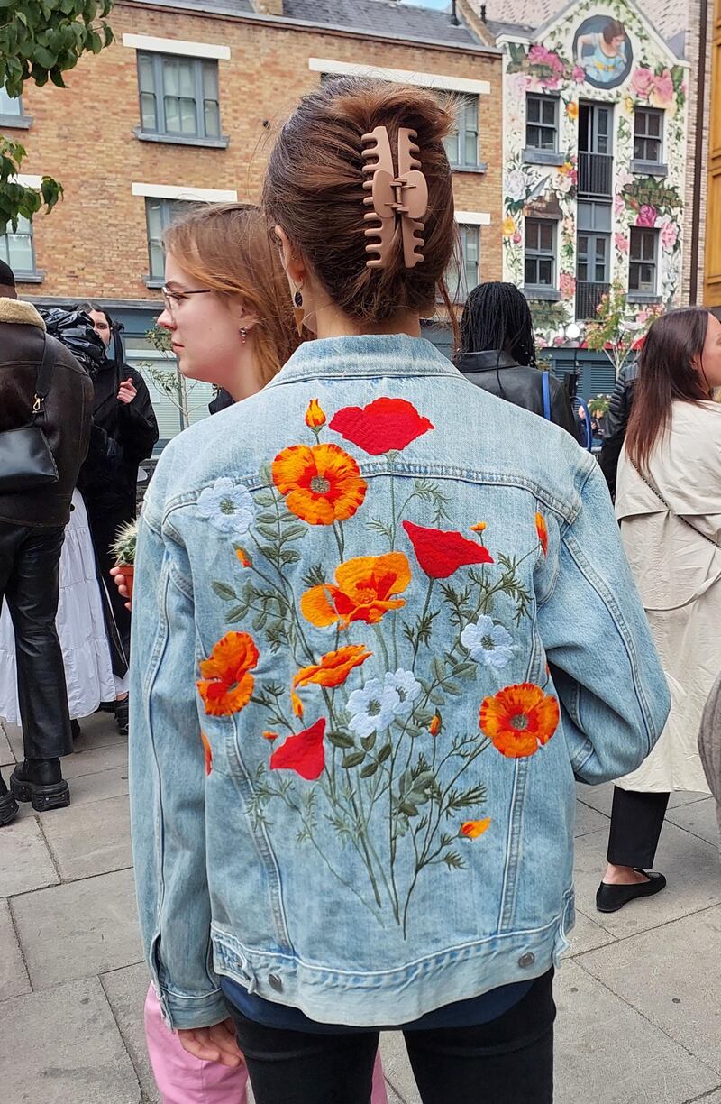 A jean jacket decorated with flowers at London Fashion Week.