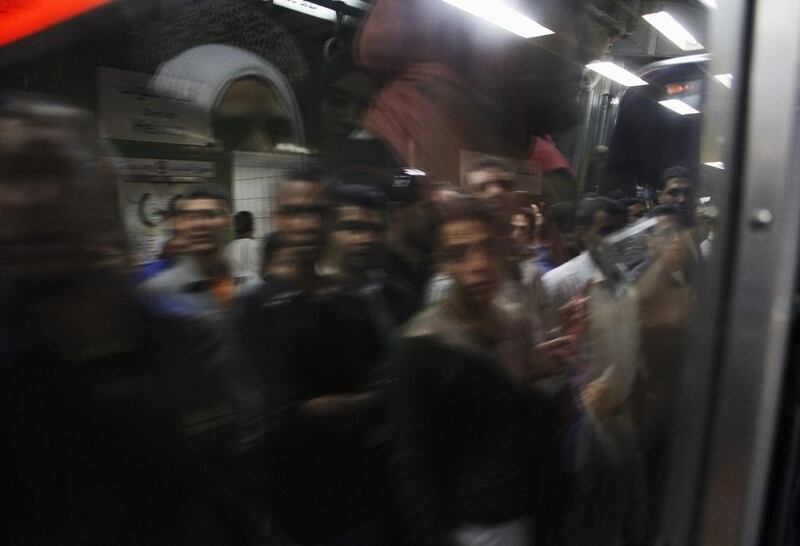Egyptian men board a car at Al Shohadaa (Martyrs) metro station.