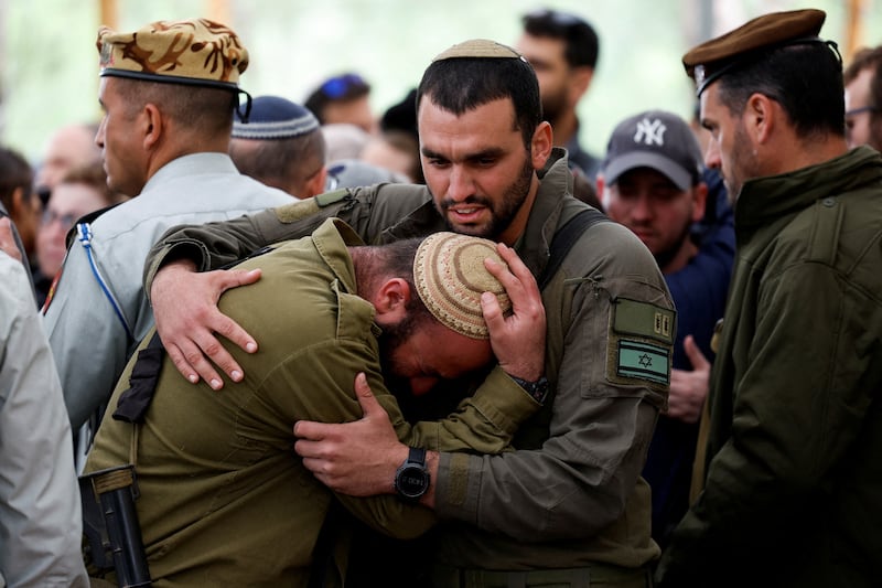 Israeli soldiers react during the funeral of Capt Liron Snir at the Mount Herzl military cemetery, Jerusalem. Reuters