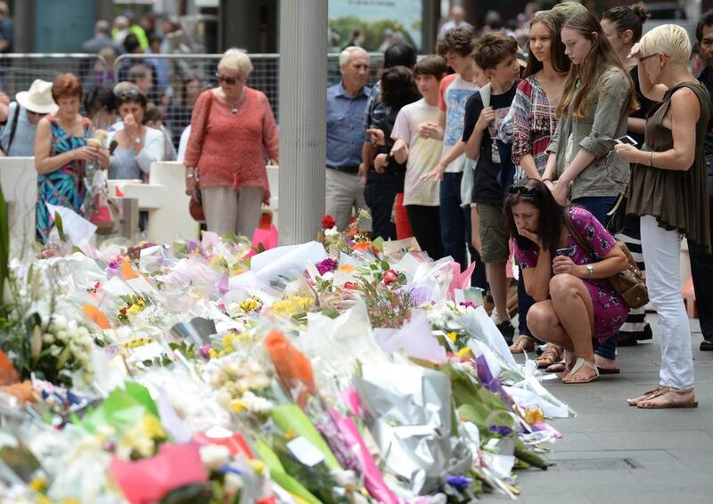 A makeshift memorial near the scene of a fatal siege in the heart of Sydney's financial district. Photo: Peter Parks / AFP