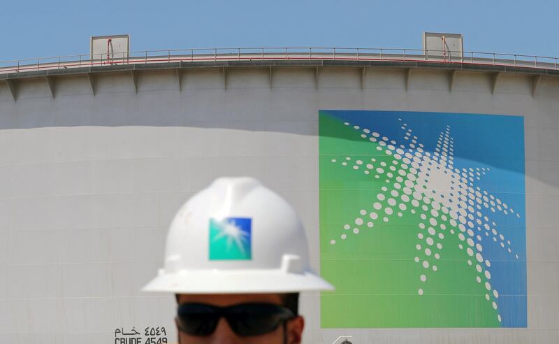 An Aramco employee walks near oil tank at Saudi Aramco's Ras Tanura oil refinery and oil terminal in Saudi Arabia May 21, 2018. Picture taken May 21, 2018. REUTERS/Ahmed Jadallah