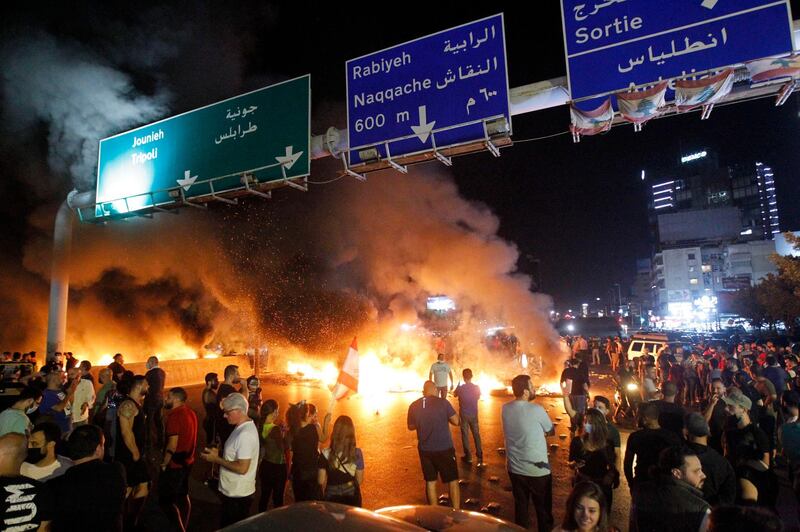Protesters burn tyres on the highway in the Antelias area north of Beirut after a further drop in the unofficial exchange rate of the Lebanese pound triggered fresh anti-government demonstrations on June 11, 2020.  EPA