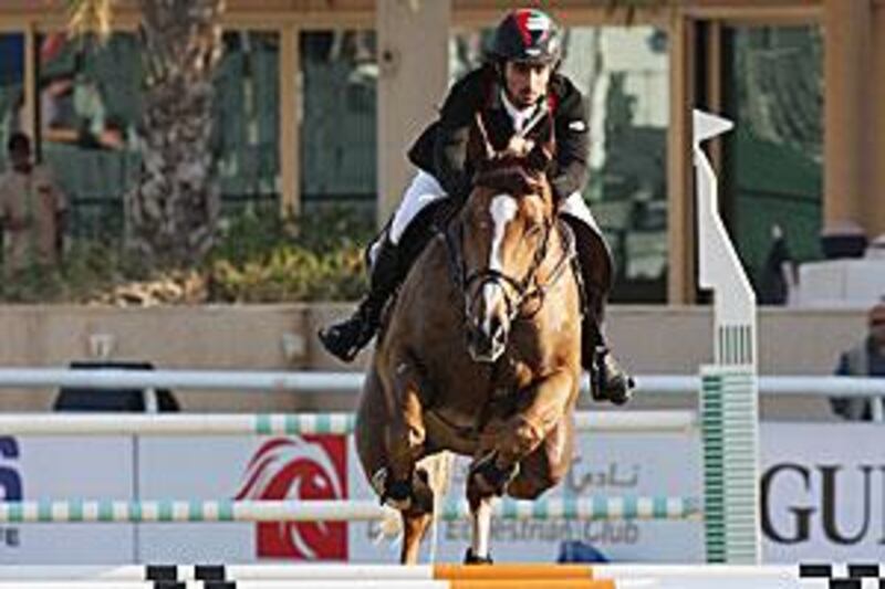 Sheikh Rashid Ahmed Al Maktoum rides Dubai's Pride during the class two competition in the Dubai Show Jumping Championship.