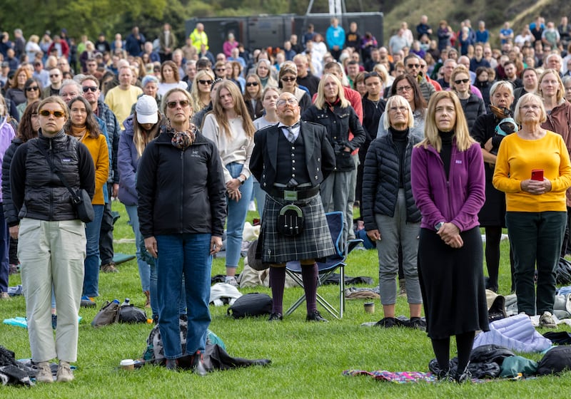 Crowds gather in Holyrood Park to watch the funeral on a large screen in Edinburgh. Getty Images