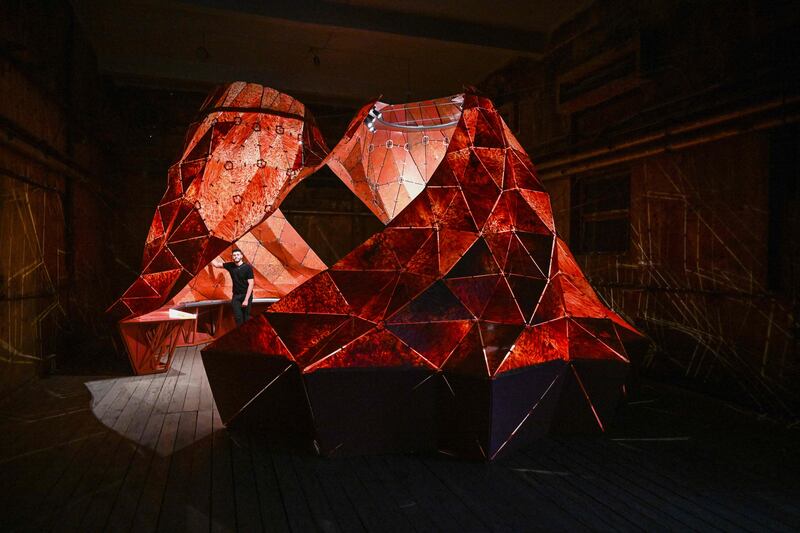 Lebanese designer Nabil Farhat poses next to an installation titled Magma Plastique and made with more than a tonne of recycled plastic, at an exhibition hall in Beirut. AFP