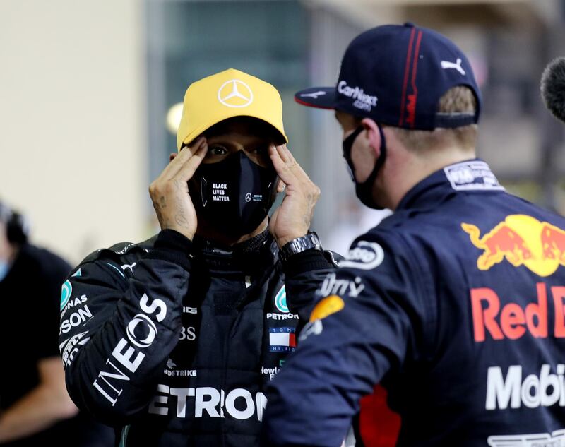 Mercedes' Lewis Hamilton speaks to Red Bull's Max Verstappen after qualifying at Yas Marina Circuit. Reuters