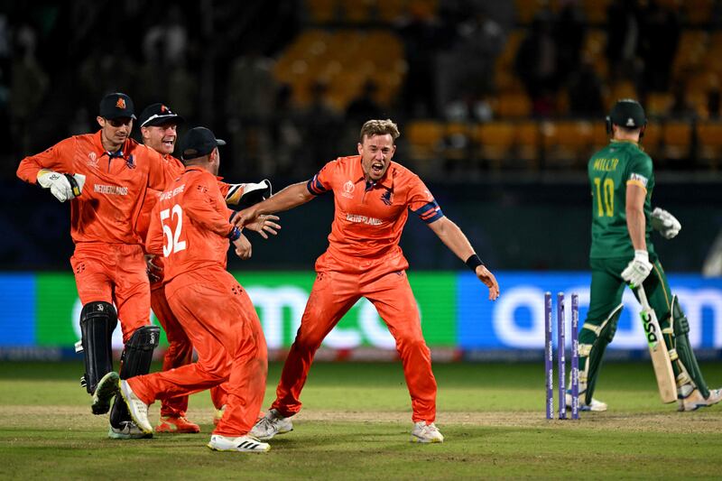 Netherlands' Logan van Beek, centre, celebrates with teammates after taking the wicket of South Africa's David Miller. AFP