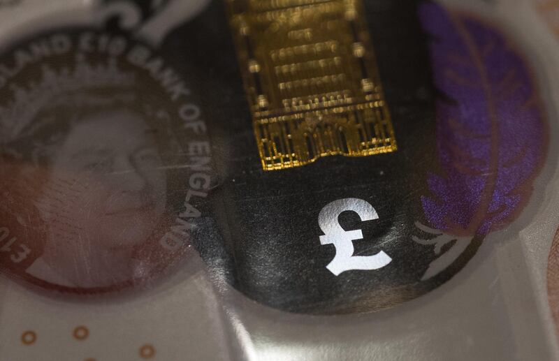 A pound watermark symbol is displayed in the security window of a British ten pound sterling banknote in this arranged photograph in London, U.K., on Monday, Aug. 5, 2019. The pound will tumble to the lowest level since 1985 if the U.K. leaves the European Union without a deal, a prospect that looks more likely now than six months ago, according to a Bloomberg survey of analysts. Photographer: Chris Ratcliffe/Bloomberg