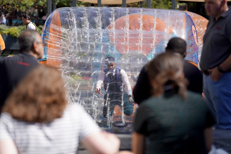 People enjoy the hot weather as they zorb on the canal at Paddington Basin in London. PA
