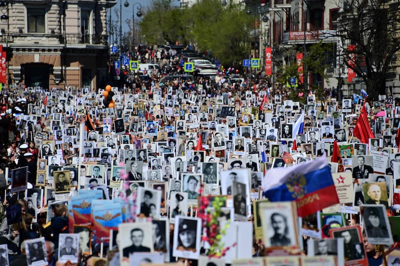 People carry portraits of their relatives who were Second World War soldiers as they take part in the Immortal Regiment march in the far eastern Russian city of Vladivostok. AFP