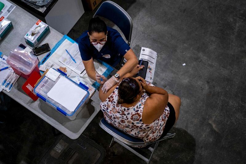 A health worker gives a shot of the Johnson and Johnson Covid-19 vaccine at the Puerto Rico Convention Centre during the first mass vaccination event in San Juan, Puerto Rico. AFP