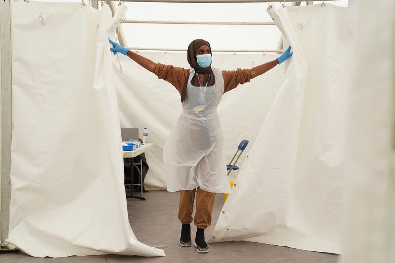 An NHS worker prepares for patients at a pop-up vaccination centre during a four-day Covid-19 vaccine festival in Langdon Park, east London.