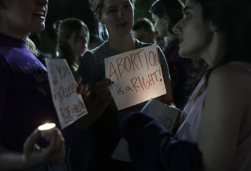 Demonstrators use candlelight during the evening protest.  AFP