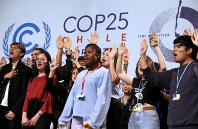 Climate change activist Greta Thunberg is seen behind young climate activists on stage at the High-Level event on Climate Emergency during the U.N. Climate Change Conference (COP25) in Madrid, Spain December 11, 2019. REUTERS/Susana Vera