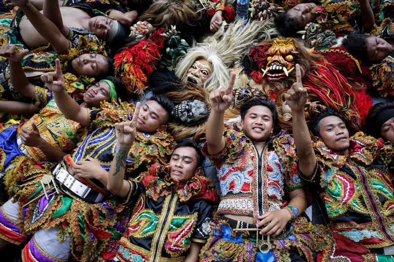 Indonesian dancers raise their fingers to show their support for the incumbent President Joko Widodo during his final campaign rally at Bung Karno stadium in Jakarta, Indonesia, 13 April 2019. EPA