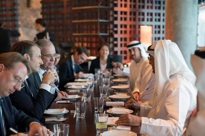 AL MARYAH ISLAND, ABU DHABI, UNITED ARAB EMIRATES - November 09, 2017: HH Sheikh Mohamed bin Zayed Al Nahyan, Crown Prince of Abu Dhabi and Deputy Supreme Commander of the UAE Armed Forces (R), meets with HE Emmanuel Macron, President of France (2nd L), at Zuma restaurant. 
( Mohamed Al Hammadi / Crown Prince Court - Abu Dhabi )
---