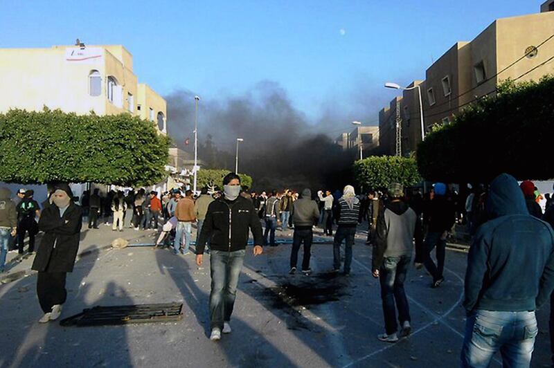 Demonstrators clash with security forces on December 23, 2010 in Sidi Bouzid, 265 km from the capital Tunis for a third day running follwing the attemted self immolation of Mohammed Bouazizi, 26, a fruit and vegetable street vendor. Clashes started after Bouazizi had his produce confiscated by authorities for not having the necessary authorisations and was refused the opportunity to plead his case with the prefect. AFP PHOTO / STR (Photo by STR / AFP)