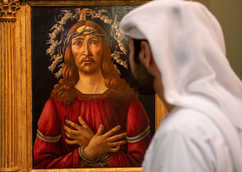 A visitor looks at Sandro Botticelli's 'The Man of Sorrows' at Sotheby's Dubai in DIFC. Ryan Lim for The National