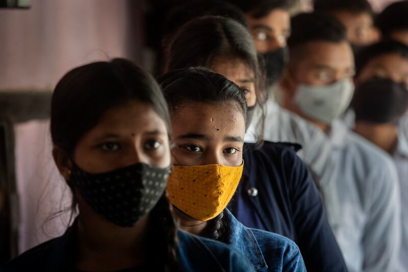 Teenage pupils queue for vaccinations at a government school in Gauhati. AP Photo