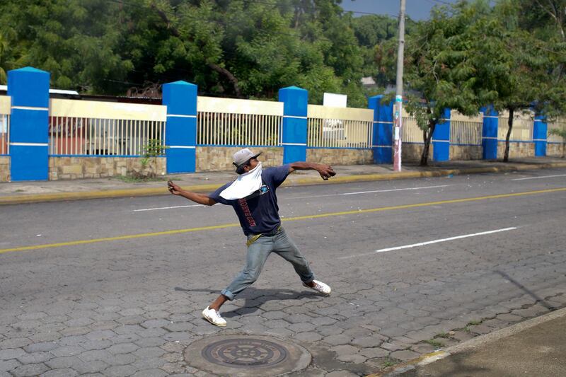 A demonstrator hurls a rock during a protest against Nicaragua's President Daniel Ortega in Managua, Nicaragua. Violence returned to Nicaragua when riot police confronted protesters and students seized a university. Esteban Felix / AP Photo