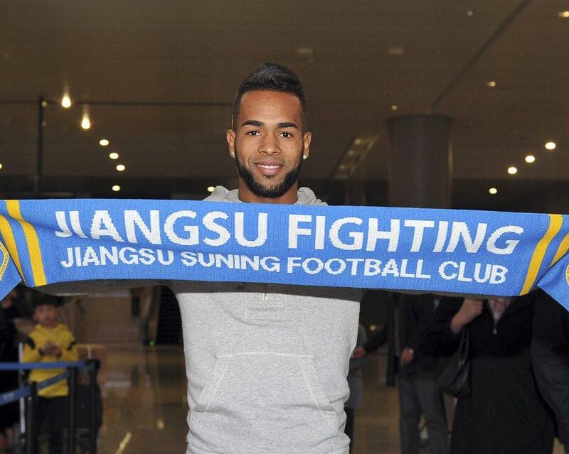 Brazilian striker Alex Teixeira poses for photos upon his arrival at the airport in Nanjing in eastern China's Jiangsu province. Chinese Super League clubs have splashed out millions in the winter transfer window on big names from Europe and South America such as Ramires, Alex Teixeira, Ezequiel Lavezzi, Jackson Martinez and Gervinho. (Color China Photo via AP)