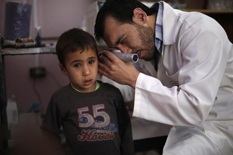 A doctor and patient in rebel-held Utaya, near the Syrian capital of Damascus. AFP