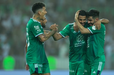 Roberto Firmino, left, Riyad Mahrez, centre, and Simian Alnabet of Al Ahli celebrate a goal against Al Tai in the Saudi Pro League. Getty