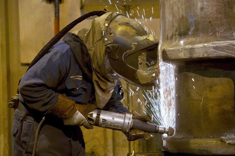 A grinder works on a freshly cast piece of steel. Oli Scarff / AFP