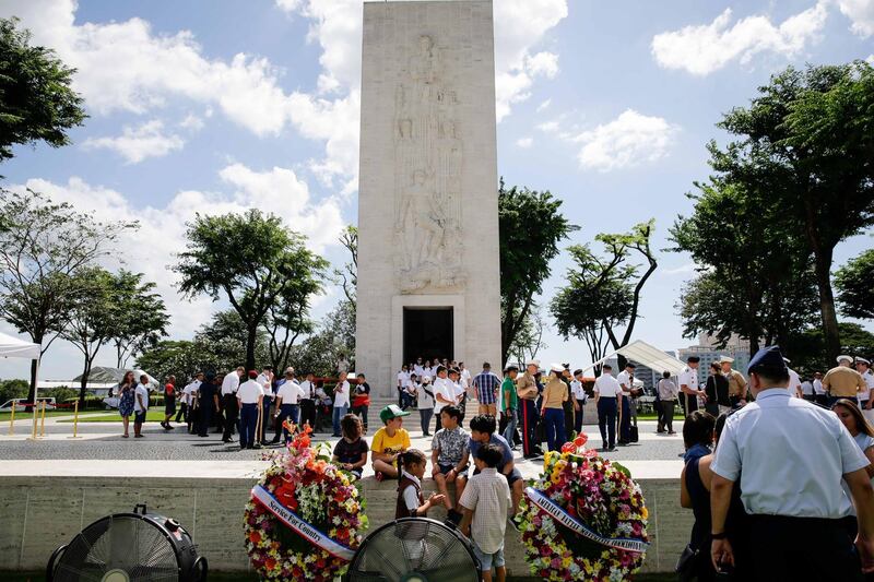 People gather during a ceremony at the Manila American Cemetery and Memorial in Taguig, Philippines. EPA