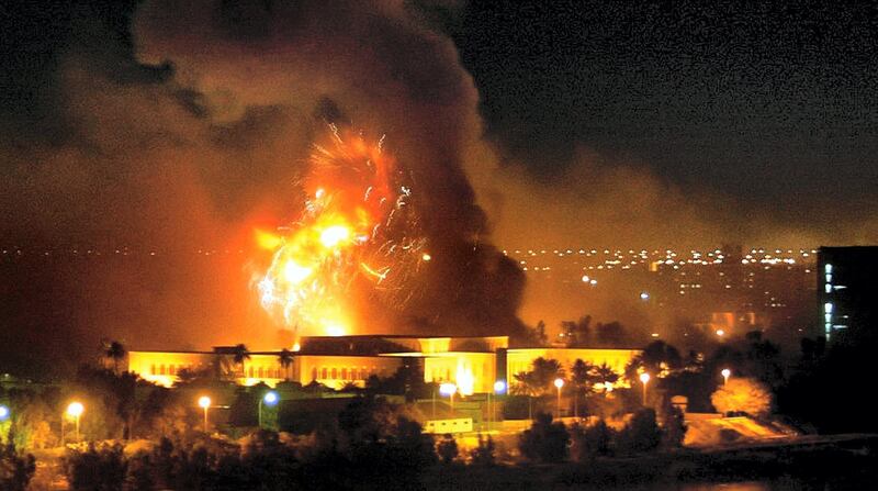 Smoke covers the presidential palace compound in Baghdad 21 March 2003 during a massive US-led air raid on the Iraqi capital. Smoke billowed from a number of targeted sites, including one of President Saddam Hussein's palaces, an AFP correspondent said.     AFP PHOTO/Ramzi HAIDAR (Photo by RAMZI HAIDAR / AFP)