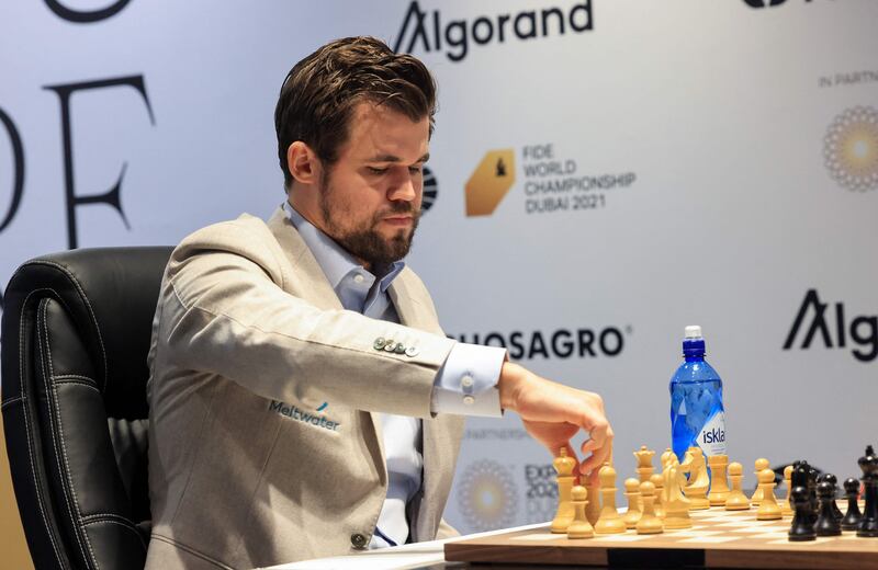 Norwegian chessmaster Magnus Carlsen competes against Russia's chessmaster Ian Nepomniachtchi (unseen) during Game 2 of the FIDE World Chess Championship Dubai 2021. AFP