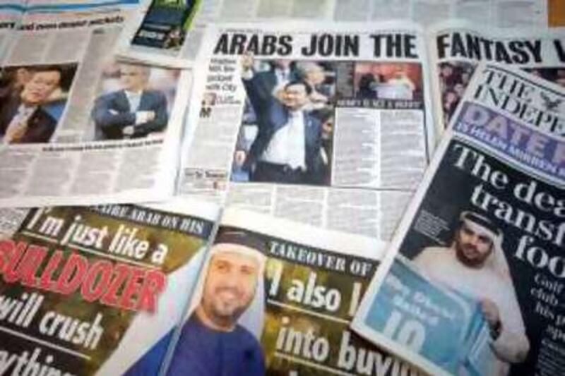 A view of newspapers displaying a story on Manchester City's takeover by the Abu Dhabi United Group for Development and Investment. PRESS ASSOCIATION Photo. Picture date: Tuesday September 2, 2008. Photo credit should read: Julia Hoyle/PA Wire *** Local Caption ***  ManCity4.jpg