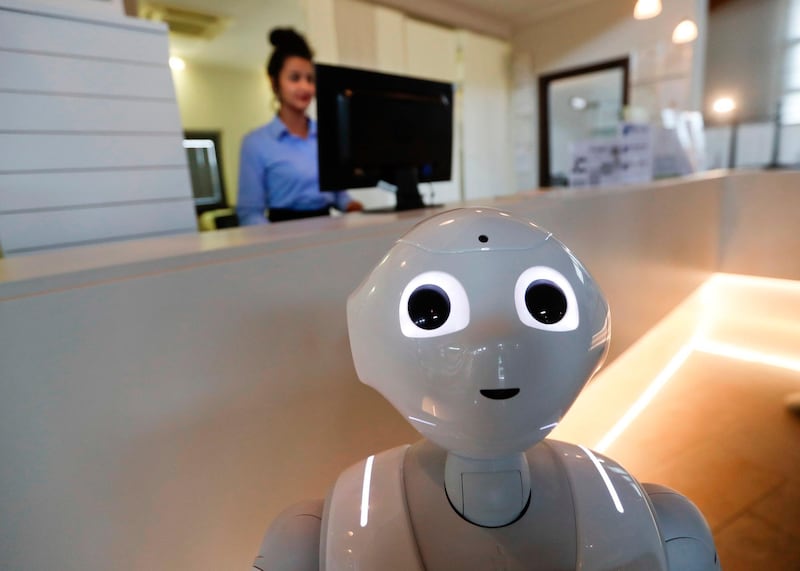 In this photo dated March 12, 2018, robot Robby Pepper stands at the front desk of hotel in Peschiera del Garda, northern Italy, Monday, March 12, 2018. Robby Pepper, billed as Italy's first robot concierge, has been programed to answer simple guest questions in Italian, English and German, the humanoid, speaking robot will be deployed all season at a hotel on the popular Garda Lake to help relieve the desk staff of simple, repetitive questions. (AP Photo/Luca Bruno)