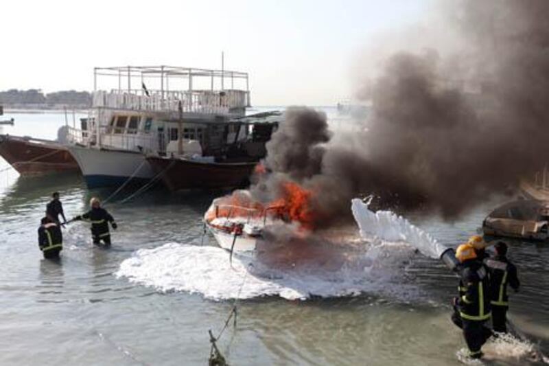 November 2, 2010/ Abu Dhabi / Firefighters respond to a fire on a boat behind Abu Dhabi Islamic Bank off of Bauiyana Street in Abu Dhabi November 2, 2010.  (Sammy Dallal / The National)



