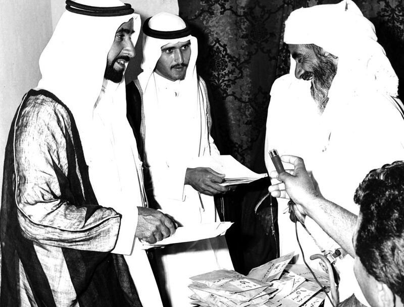 Sheikh Zayed distributes property deeds to their new owners at Al Ain Palace in 1969.