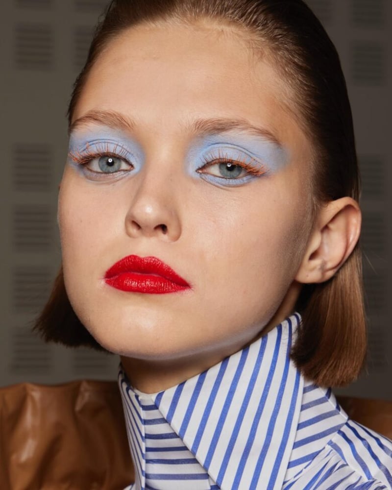 1980's era blue eye shadow and a bright lip at the Viktor & Rolf autumn/winter 2022 haute couture show. Getty