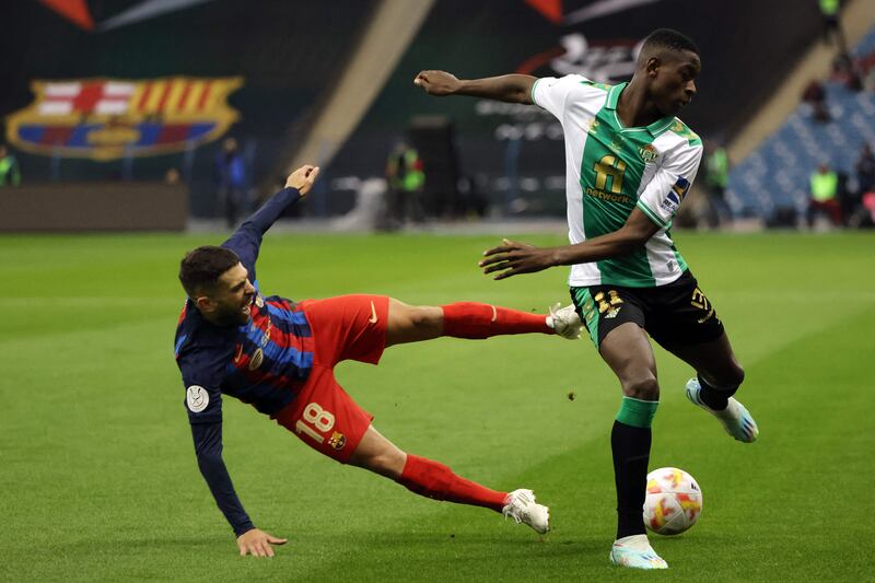 Barca defender Jordi Alba falls next to Betis' Luiz Henrique. AFP