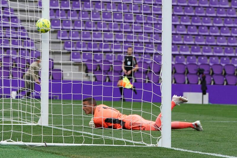 Valladolid's goalkeeper Jordi Masip fails to stop a shot from Atletico Madrid's forward Angel Correa. AFP