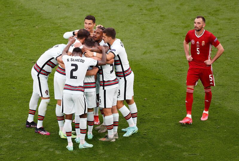 Raphael Guerreiro is mobbed by teammates after breaking the deadlock in Budapest. Getty