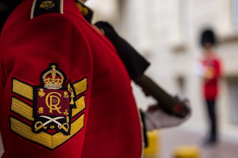 The new badge for the Grenadier Guards with the  king's initial. PA