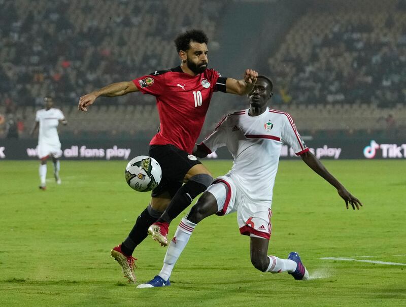 Egypt's Mohamed Salah, left, is challenged by Sudan's Mustapha Abdelgader Karshoum. AP Photo