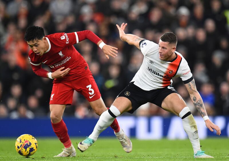 Liverpool's Wataru Endo fights for the ball with Luton's Ross Barkley. EPA