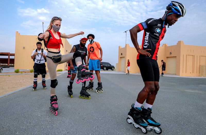 Abu Dhabi, United Arab Emirates, August 21, 2020.   The Madrollers skating group at the Al Wathba Bicycle Track do a  8 km. fun sprint.
  The skating group has members from Dubai and Abu Dhabi.  They encourage safety and discipline on roller-skates, skateboard, long-board and bicycles.  --Rollerbladers do limbering exercises before going on the 8 km fun sprint. —  Liselotte of the Netherlands balances on a single leg before the sprint..
Victor Besa /The National
Section:  Photo Project
Reporter: