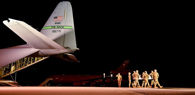 Members of the US Air Force carry the body of Ensign Joshua Caleb Watson, of Coffee, Alabama, during the transfer of three soldiers killed in a mass shooting at Dover Air Force Base in Dover, Delaware.  EPA