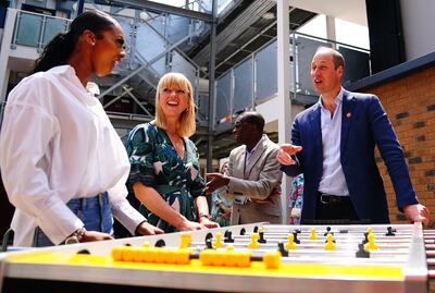 Prince William, right, and radio broadcaster Sara Cox, centre, attend the opening of Centrepoint's Reuben House in London on June 13. AFP
