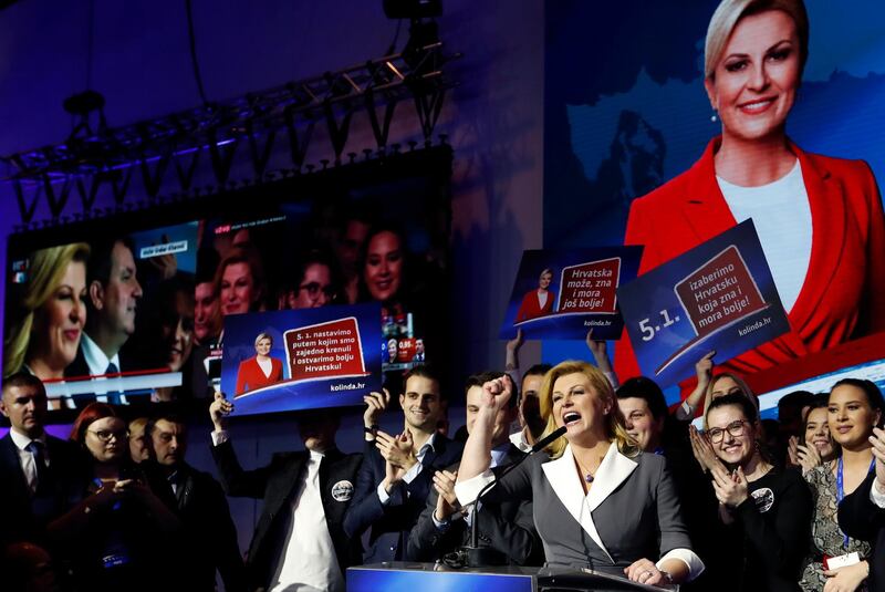 Incumbent president and presidential candidate Kolinda Grabar Kitarovic, center, greets supporters in her headquarter in Zagreb, Croatia, Sunday, Dec. 22, 2019. The race for Croatia's next president is heading to a runoff vote. A preliminary count from an election held Sunday showed neither the incumbent nor any of the 10 other candidates won the office outright. With nearly all ballots counted, liberal opposition candidate Zoran Milanovic was leading the race with nearly 30% support. (AP Photo/Darko Vojinovic)