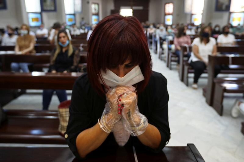 People wearing face masks attend a mass at the Church of Mary of Nazareth as places of worship reopen in Jordan after more than two months, in central Amman, Jordan. Reuters