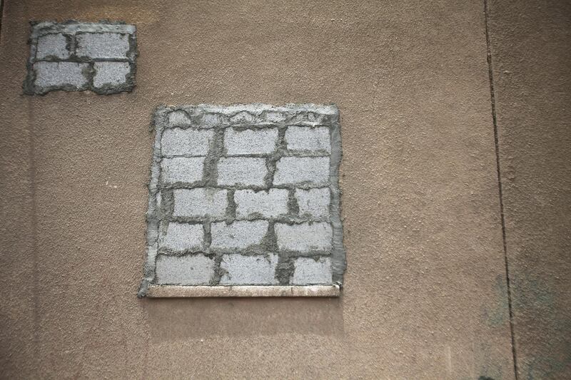 Dubai, UAE, July 8, 2012:
Vacated apartments in the Sheikh Rashid compound can be identified by their cement block windows.
The residents of the area were told on June 1st via text message that they would have to vacate their homes by mid july at the very latest. 

Lee Hoagland/The National